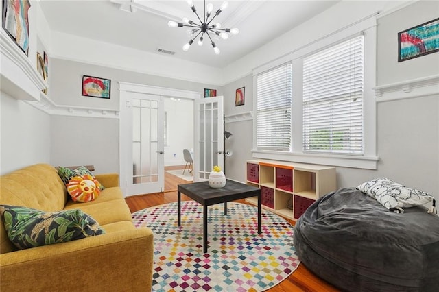 2933 Calhoun St Unit 2933, New Orleans, LA 70118 - living room featuring french doors, a chandelier, and wood finished floors