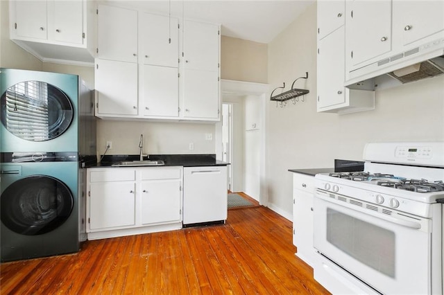 2933 Calhoun St Unit 2933, New Orleans, LA 70118 - kitchen with white appliances, stacked washing machine and dryer, a sink, and white cabinets