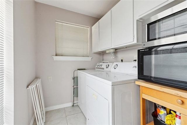 4508 Hastings St, Metairie, LA 70006 - laundry area featuring washing machine and dryer, baseboards, light tile patterned flooring, and cabinet space