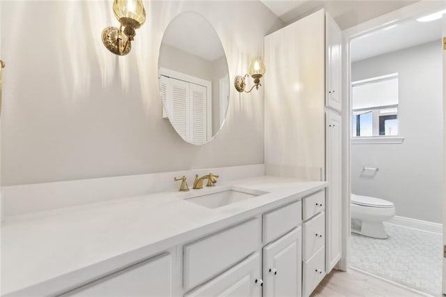 4901 Friar Tuck Dr, New Orleans, LA 70128 - bathroom with vanity, toilet, and baseboards