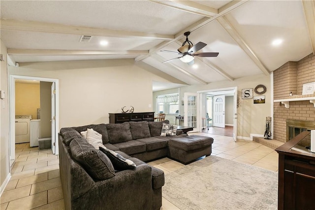 3121 Arbutus Ln, Marrero, LA 70072 - living room with light tile patterned floors, washing machine and dryer, ceiling fan, baseboards, and a brick fireplace
