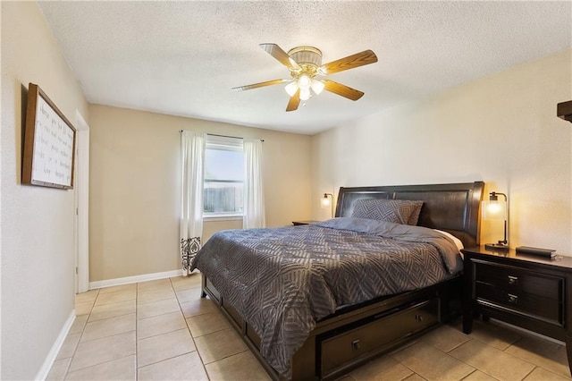 3121 Arbutus Ln, Marrero, LA 70072 - bedroom featuring light tile patterned flooring, a textured ceiling, a ceiling fan, and baseboards