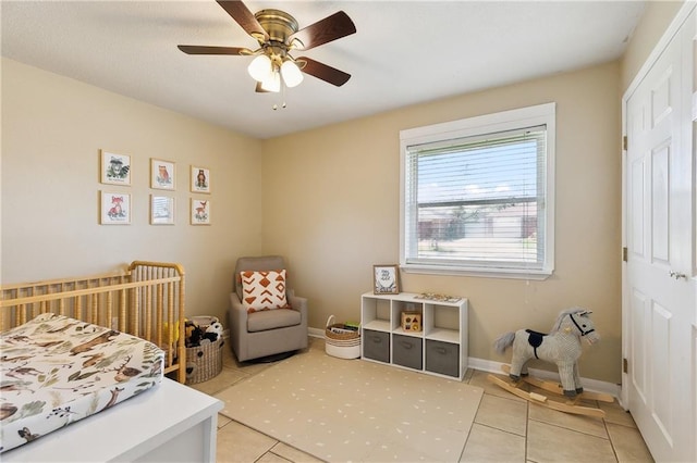 3121 Arbutus Ln, Marrero, LA 70072 - bedroom featuring light tile patterned floors, a ceiling fan, and baseboards