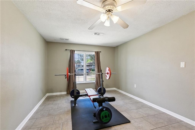 3121 Arbutus Ln, Marrero, LA 70072 - workout area featuring a textured ceiling, light tile patterned floors, ceiling fan, and baseboards