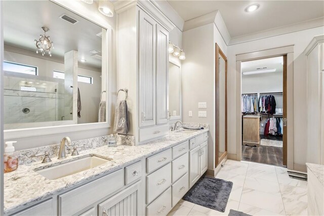 500 Tallow Tree Dr, Madisonville, LA 70447 - full bathroom featuring double vanity, walk in shower, a walk in closet, crown molding, and marble finish floors