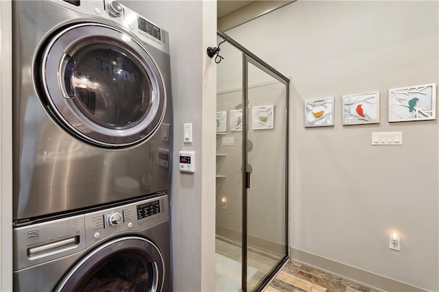 500 Tallow Tree Dr, Madisonville, LA 70447 - washroom featuring estacked washer and dryer, wood finished floors, and baseboards