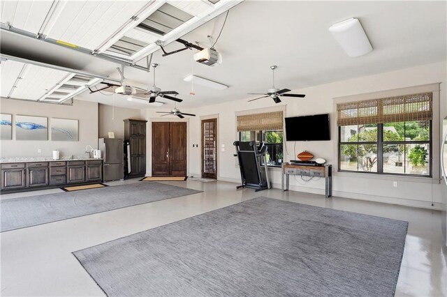 500 Tallow Tree Dr, Madisonville, LA 70447 - garage with freestanding refrigerator, a garage door opener, and a ceiling fan