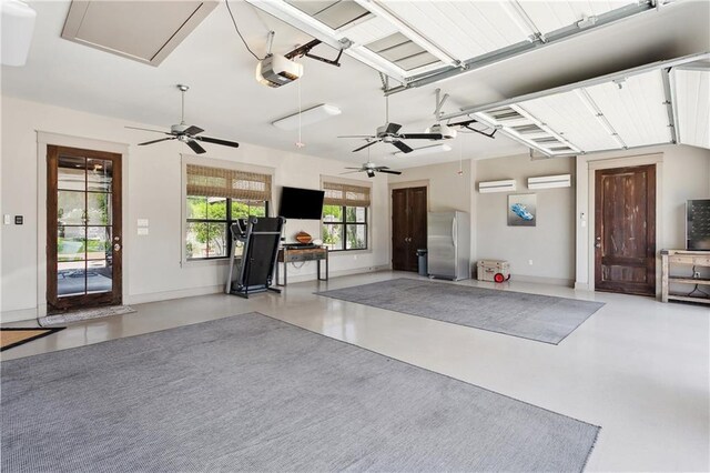 500 Tallow Tree Dr, Madisonville, LA 70447 - garage with freestanding refrigerator, ceiling fan, a garage door opener, and a wall mounted air conditioner
