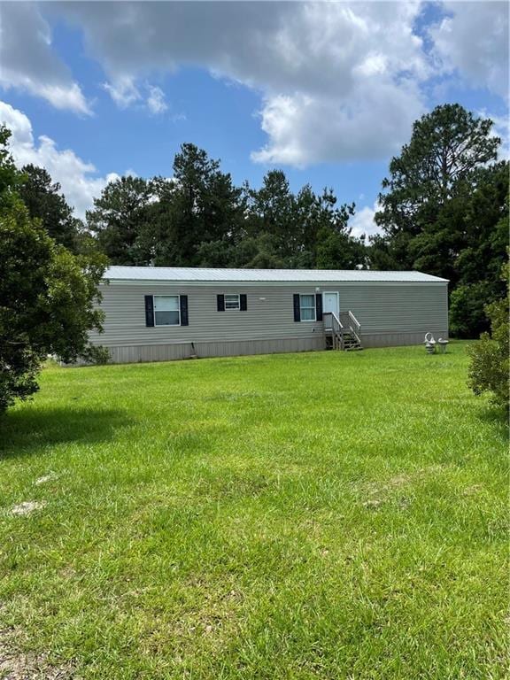 22056 Chappepeela Rd, Loranger, LA 70446 - rear view of house with a lawn