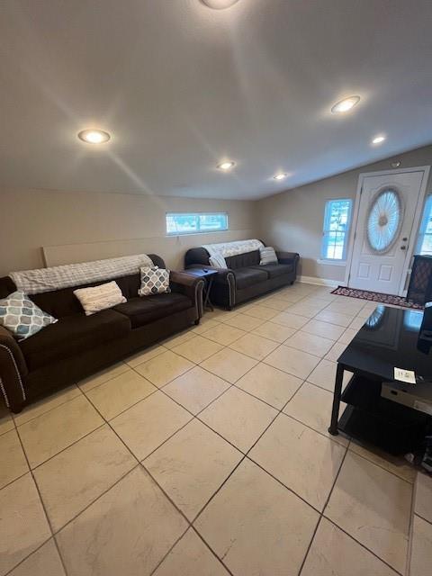 5917 Campus Blvd, New Orleans, LA 70126 - living area featuring plenty of natural light, light tile patterned floors, lofted ceiling, and recessed lighting