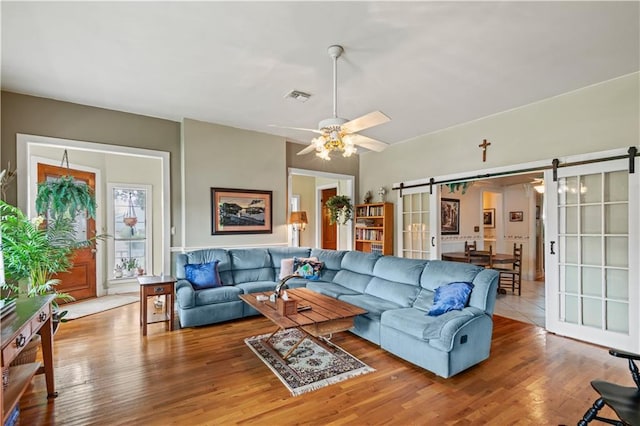 237 Villere Dr, Destrehan, LA 70047 - living area featuring a barn door, wood finished floors, and ceiling fan
