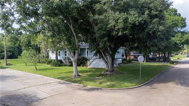 237 Villere Dr, Destrehan, LA 70047 - view of property hidden behind natural elements with a front lawn and stairway