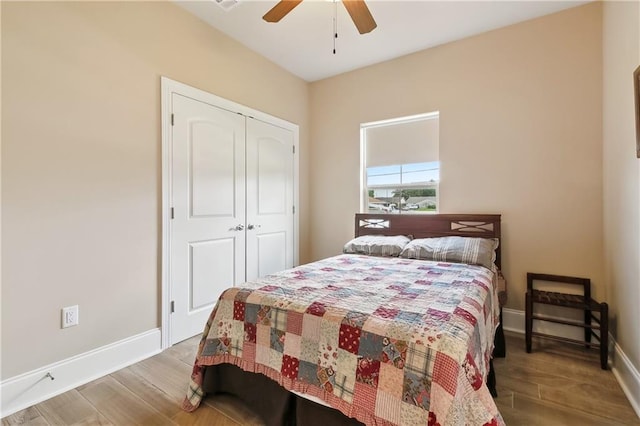5001 Randolph St, Marrero, LA 70072 - bedroom with wood finished floors, baseboards, a closet, and a ceiling fan