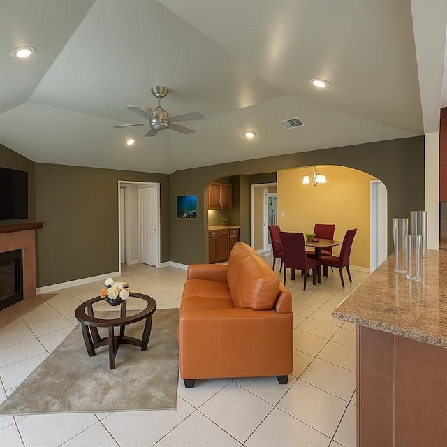 13801 Horizon Dr, New Orleans, LA 70129 - living room with arched walkways, light tile patterned flooring, vaulted ceiling, ceiling fan, and recessed lighting