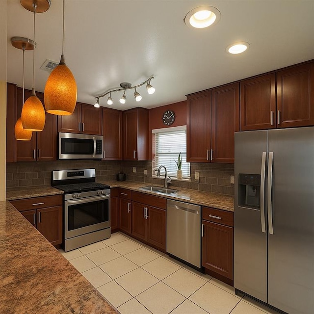 13801 Horizon Dr, New Orleans, LA 70129 - kitchen featuring appliances with stainless steel finishes, a sink, light tile patterned flooring, and decorative backsplash