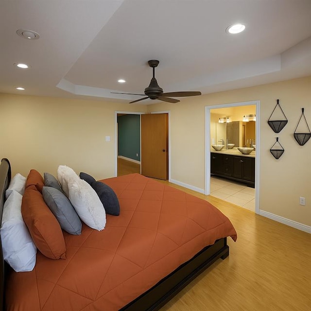 13801 Horizon Dr, New Orleans, LA 70129 - bedroom featuring a raised ceiling, baseboards, recessed lighting, ceiling fan, and ensuite bath