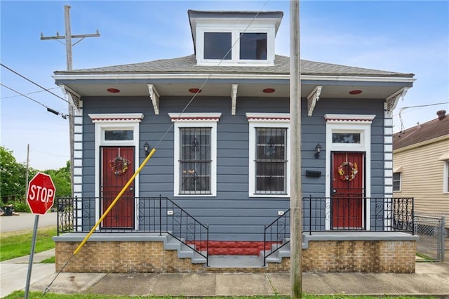 5530 Dauphine St, New Orleans, LA 70117 - shotgun-style home with roof with shingles