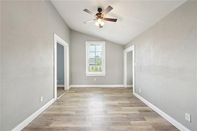 5530 Dauphine St, New Orleans, LA 70117 - empty room with a ceiling fan, lofted ceiling, light wood-style flooring, and baseboards