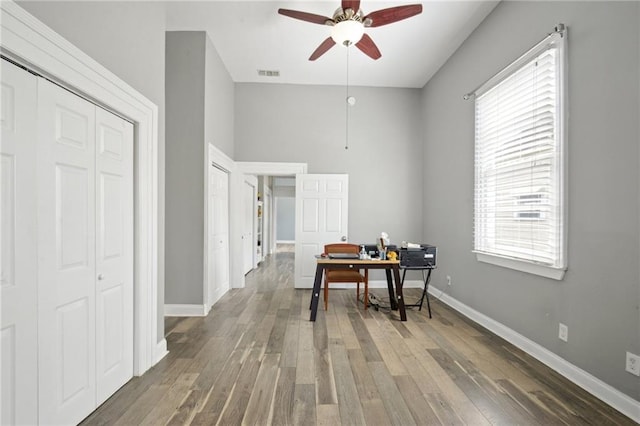 5530 Dauphine St, New Orleans, LA 70117 - office area featuring ceiling fan, wood finished floors, and baseboards