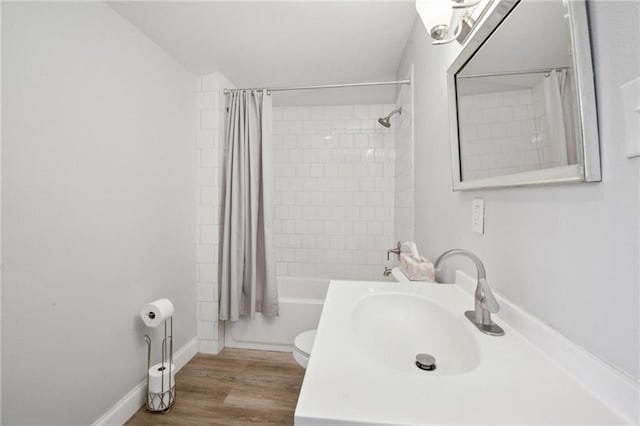 5530 Dauphine St, New Orleans, LA 70117 - full bathroom with vanity, toilet, shower / tub combo, and wood finished floors