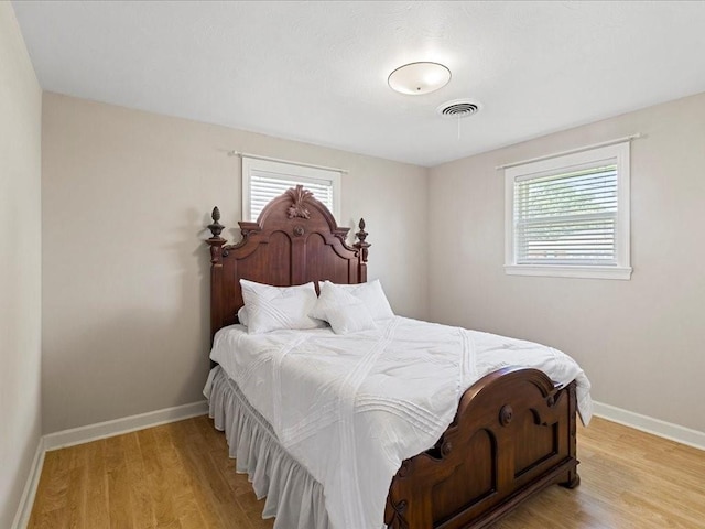 4536 Jasper St, Metairie, LA 70006 - bedroom with multiple windows, light wood-type flooring, and baseboards