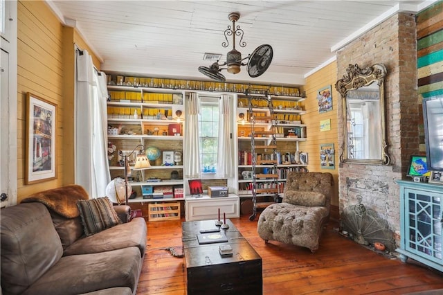 518 Pacific Ave, New Orleans, LA 70114 - living area with hardwood / wood-style flooring, plenty of natural light, wooden walls, and ceiling fan