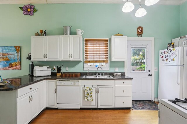 518 Pacific Ave, New Orleans, LA 70114 - kitchen featuring white appliances, a sink, light wood finished floors, white cabinets, and a peninsula