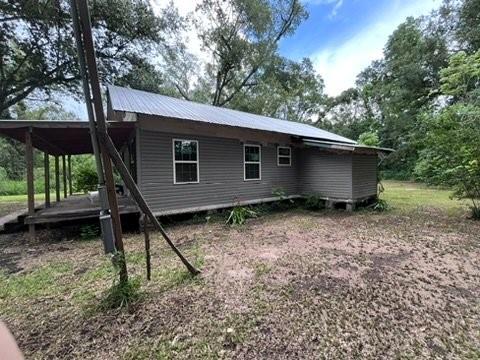 99 White St, Hammond, LA 70403 - rear view of house with metal roof