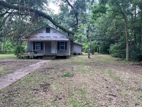 99 White St, Hammond, LA 70403 - view of front facade with a porch and a wooded view
