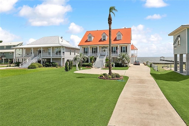279 Debbie Dr, Slidell, LA 70458 - view of building exterior featuring stairway, concrete driveway, and a water view