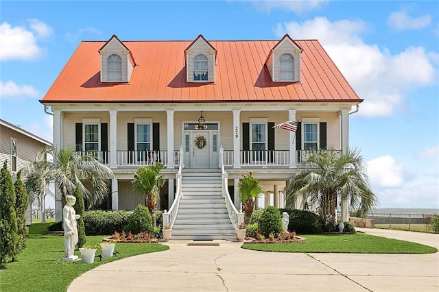 279 Debbie Dr, Slidell, LA 70458 - view of front of house featuring covered porch, stairway, a front lawn, metal roof, and driveway