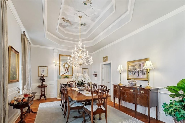 279 Debbie Dr, Slidell, LA 70458 - dining space featuring a raised ceiling, wood finished floors, a chandelier, ornamental molding, and wainscoting
