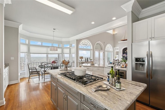 279 Debbie Dr, Slidell, LA 70458 - kitchen featuring stainless steel appliances, crown molding, a sink, light stone countertops, and wine cooler
