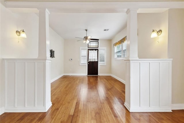 2609 General Pershing St, New Orleans, LA 70115 - entryway featuring light wood-style floors, ornate columns, ceiling fan, and baseboards