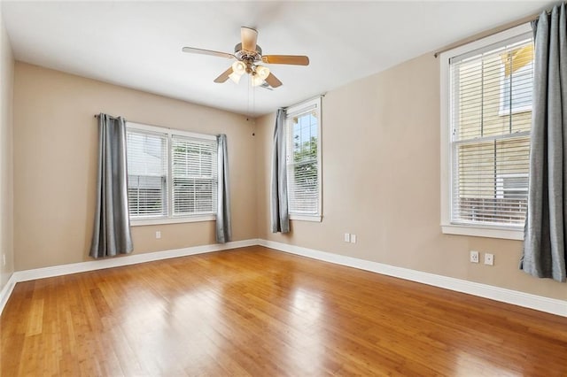 2609 General Pershing St, New Orleans, LA 70115 - empty room with wood finished floors, a ceiling fan, and baseboards
