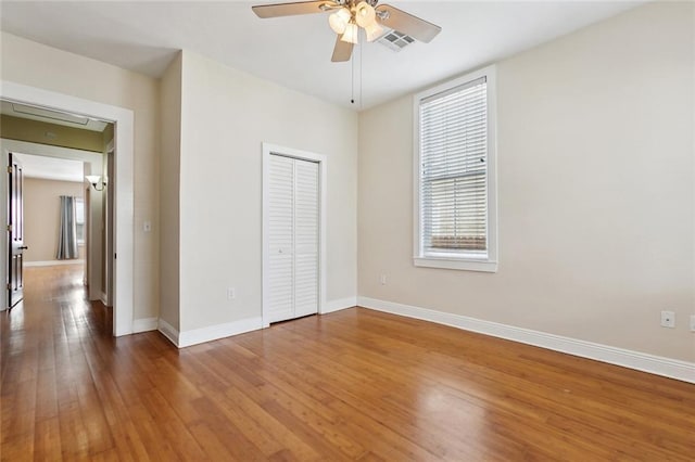 2609 General Pershing St, New Orleans, LA 70115 - unfurnished bedroom with hardwood / wood-style flooring, baseboards, a closet, and ceiling fan
