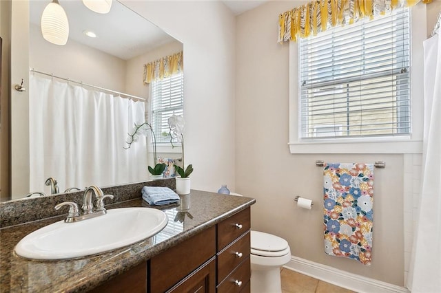 2609 General Pershing St, New Orleans, LA 70115 - full bath with healthy amount of natural light, vanity, toilet, and tile patterned floors