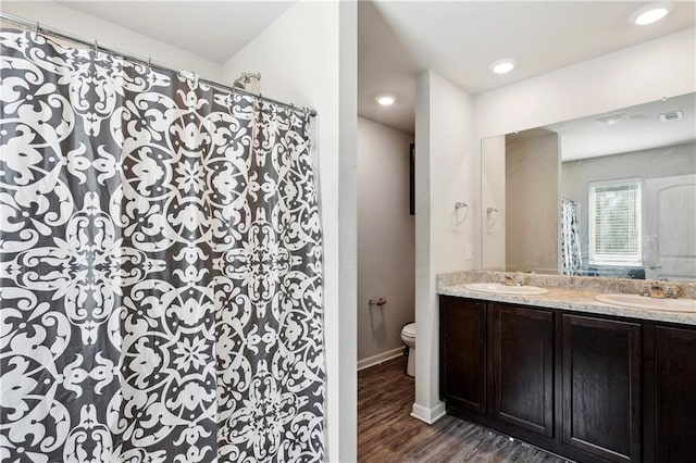 18181 Fox Hollow Loop, Hammond, LA 70401 - full bathroom featuring toilet, double vanity, wood finished floors, a shower with curtain, and recessed lighting