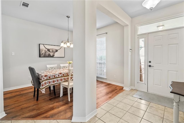 526 Moore Blvd, Covington, LA 70433 - entryway featuring a chandelier, light wood-type flooring, and baseboards