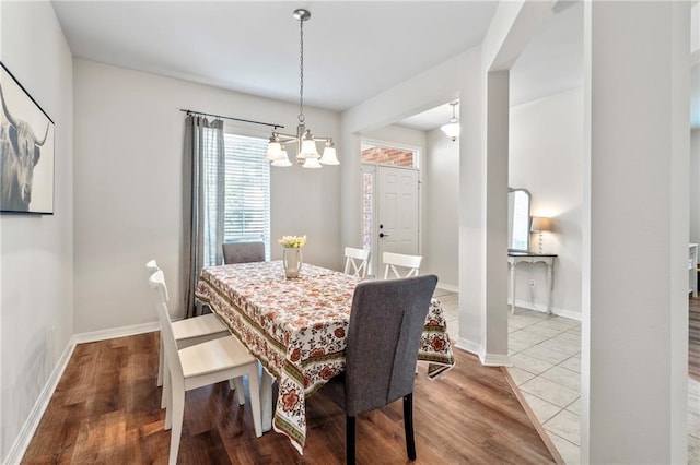 526 Moore Blvd, Covington, LA 70433 - dining space with a chandelier, wood finished floors, and baseboards