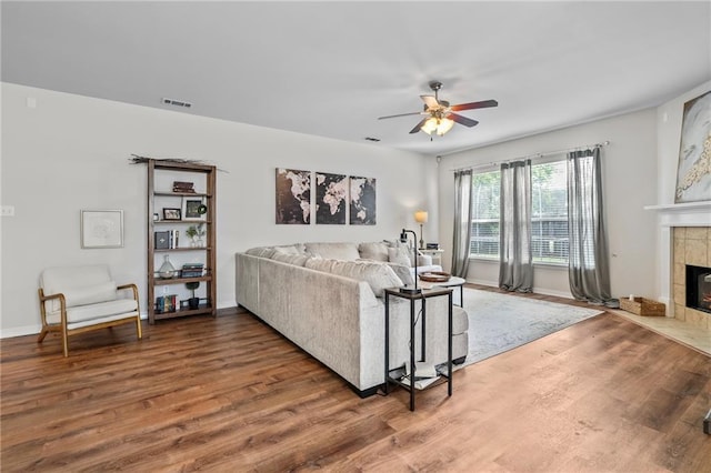 526 Moore Blvd, Covington, LA 70433 - living area featuring wood finished floors, a ceiling fan, and a fireplace
