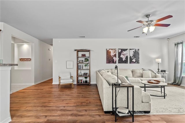 526 Moore Blvd, Covington, LA 70433 - living area featuring wood finished floors, ceiling fan, and baseboards