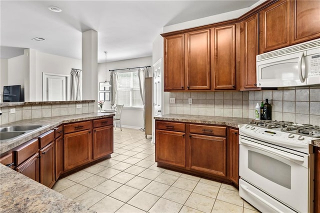 526 Moore Blvd, Covington, LA 70433 - kitchen with white appliances, tasteful backsplash, and light tile patterned floors