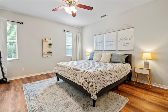 526 Moore Blvd, Covington, LA 70433 - bedroom featuring multiple windows, wood finished floors, baseboards, and ceiling fan