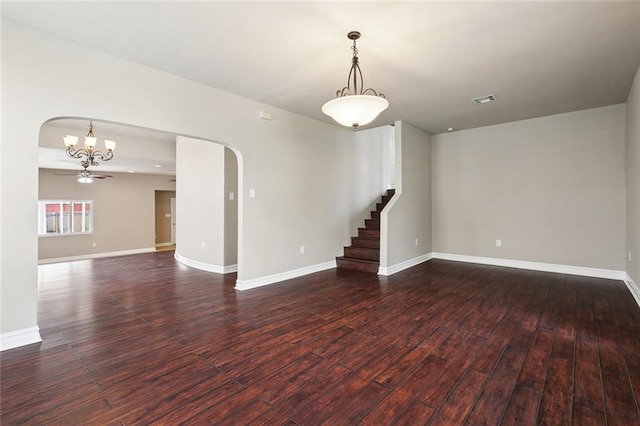 6409 Louis Xiv St, New Orleans, LA 70124 - unfurnished room featuring arched walkways, a chandelier, wood finished floors, stairs, and baseboards
