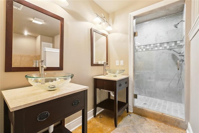 6409 Louis Xiv St, New Orleans, LA 70124 - bathroom featuring a stall shower, two vanities, and baseboards