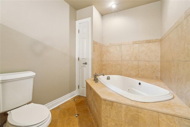 6409 Louis Xiv St, New Orleans, LA 70124 - full bathroom with toilet, a whirlpool tub, baseboards, and tile patterned flooring