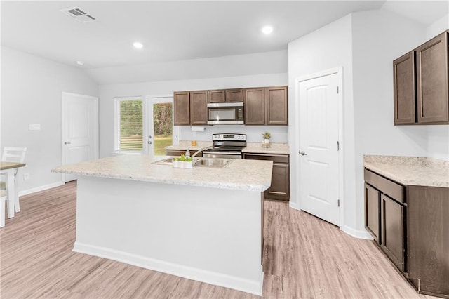 18349 Fox Hollow Loop, Hammond, LA 70401 - kitchen with appliances with stainless steel finishes, light wood-style floors, vaulted ceiling, dark brown cabinets, and a sink