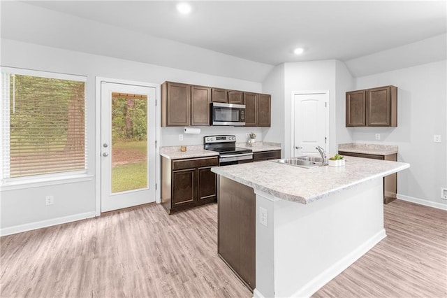 18349 Fox Hollow Loop, Hammond, LA 70401 - kitchen with appliances with stainless steel finishes, light wood finished floors, a sink, light countertops, and lofted ceiling