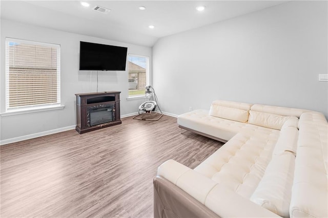 18349 Fox Hollow Loop, Hammond, LA 70401 - living area with a glass covered fireplace, wood finished floors, baseboards, and recessed lighting